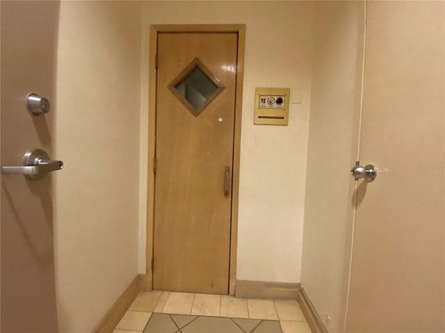 hall featuring light tile patterned floors