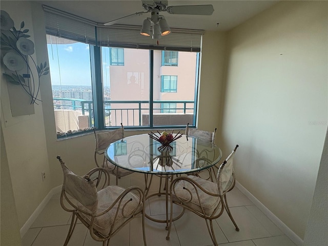 dining area with ceiling fan and light tile patterned floors