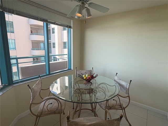 dining room with ceiling fan and tile patterned flooring