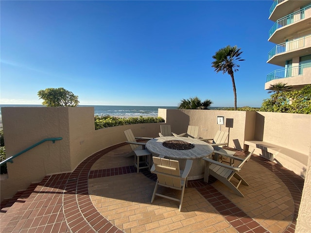 view of patio / terrace with a water view and an outdoor fire pit