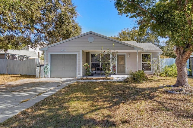 ranch-style home featuring a front yard, a porch, and a garage