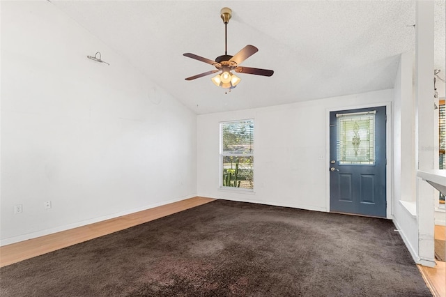 spare room featuring a textured ceiling, hardwood / wood-style flooring, high vaulted ceiling, and ceiling fan