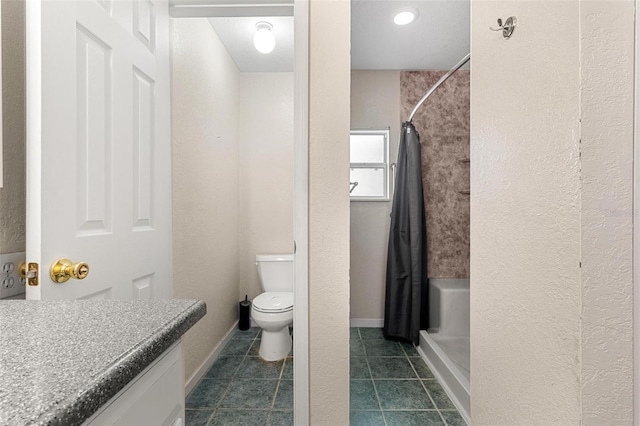 bathroom with tile patterned floors, vanity, toilet, and walk in shower