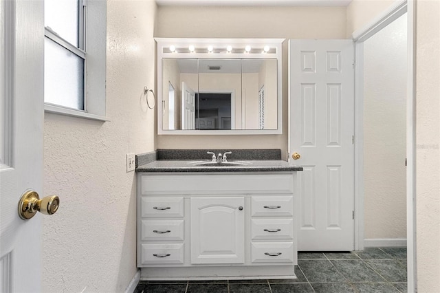 bathroom with tile patterned flooring and vanity