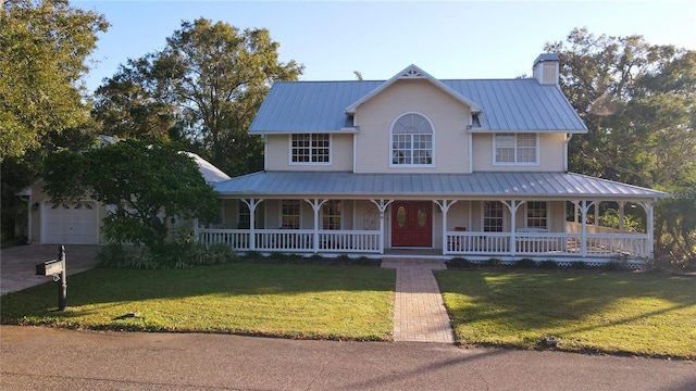 farmhouse with a garage and a front lawn