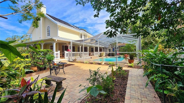 rear view of house with a patio and a lanai