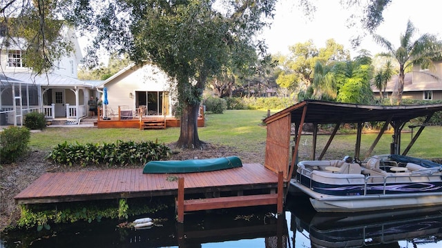 dock area featuring a lawn and a deck