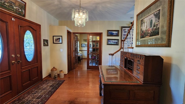 entrance foyer with light wood-type flooring and an inviting chandelier