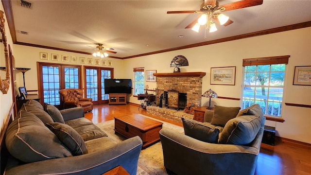 living room featuring hardwood / wood-style flooring, ceiling fan, and crown molding