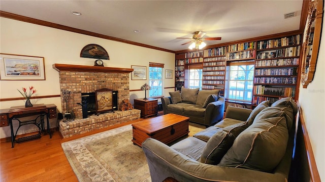 living room with light hardwood / wood-style flooring, ceiling fan, and crown molding