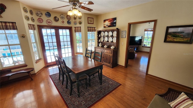 dining area with ceiling fan, french doors, a textured ceiling, and hardwood / wood-style flooring