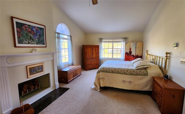 bedroom featuring ceiling fan, carpet floors, and vaulted ceiling