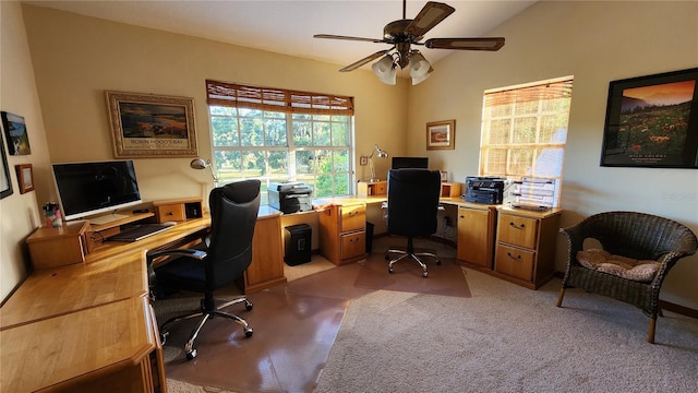 carpeted home office featuring vaulted ceiling and ceiling fan