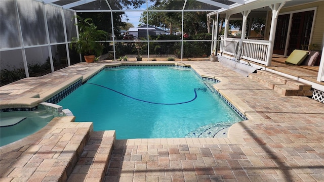 view of swimming pool featuring an in ground hot tub, a lanai, and a patio area