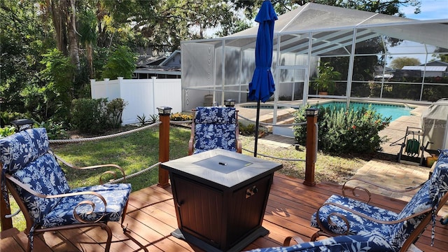 wooden deck featuring a lanai and a pool with hot tub