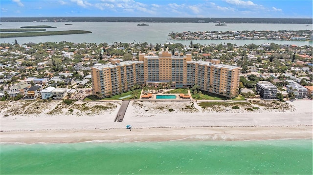 bird's eye view featuring a water view and a beach view