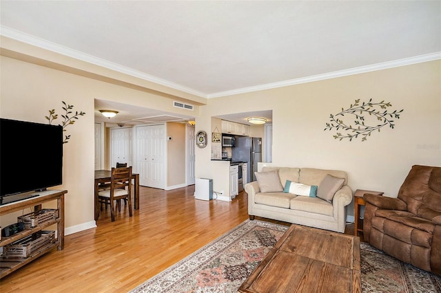 living room featuring light hardwood / wood-style floors and ornamental molding