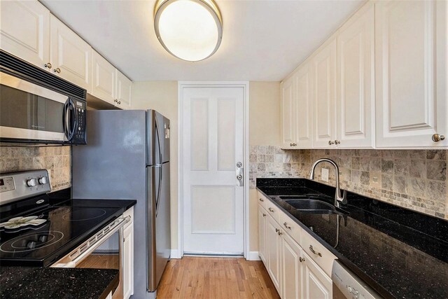 kitchen featuring sink, white cabinets, and stainless steel appliances