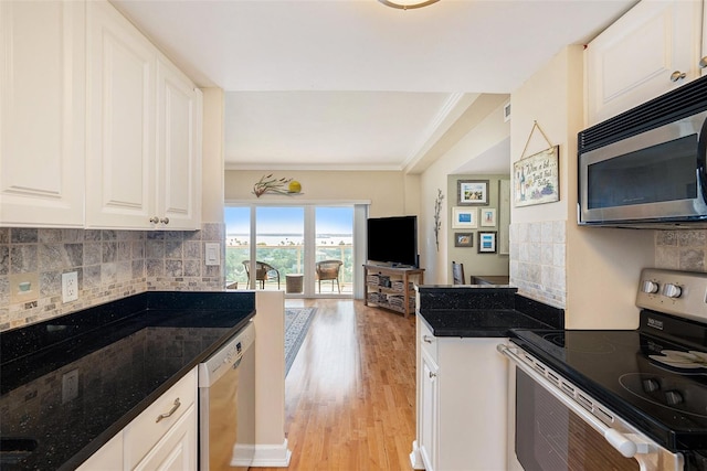 kitchen featuring backsplash, white cabinets, crown molding, light wood-type flooring, and stainless steel appliances