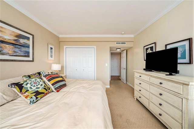 carpeted bedroom featuring ornamental molding and a closet