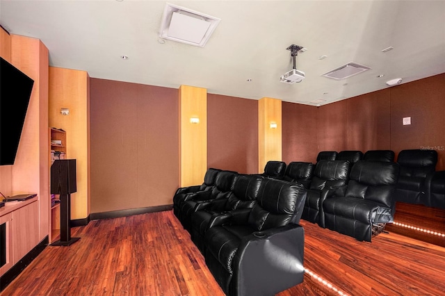 cinema room featuring dark wood-type flooring