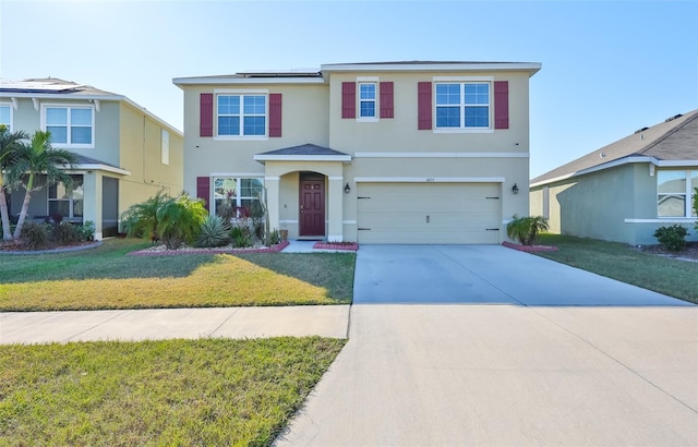 view of front of property with a front yard and a garage