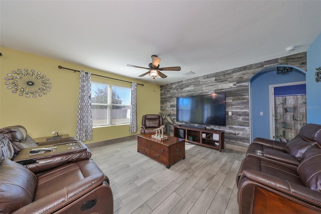 living room with ceiling fan and light hardwood / wood-style floors