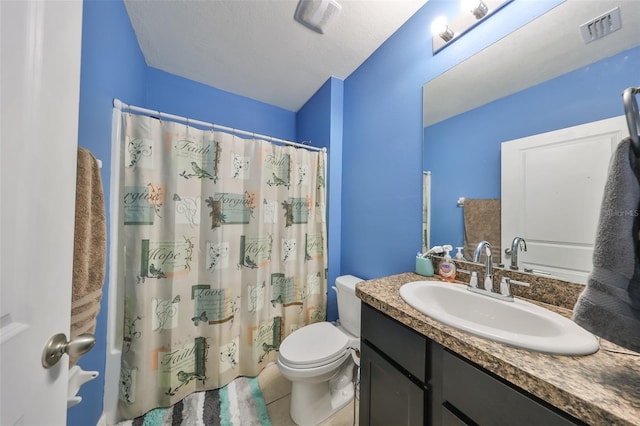 bathroom featuring a shower with shower curtain, tile patterned floors, a textured ceiling, vanity, and toilet