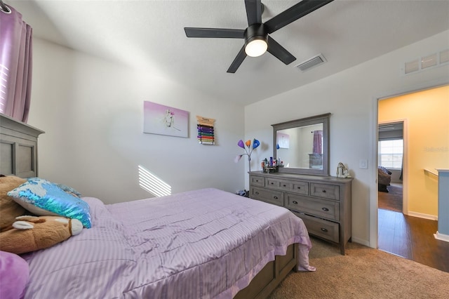 bedroom with dark hardwood / wood-style floors and ceiling fan