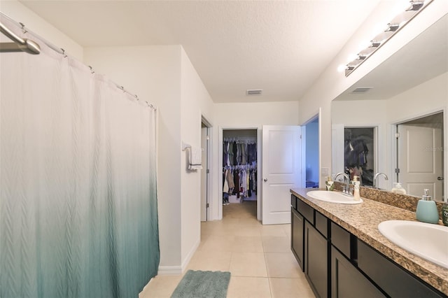 bathroom featuring a textured ceiling, vanity, and tile patterned floors