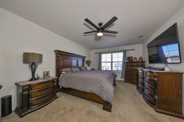 bedroom with ceiling fan and light carpet