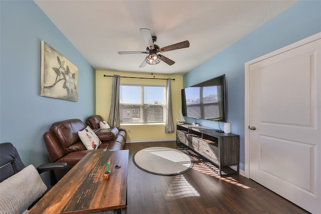 living room with ceiling fan and dark wood-type flooring