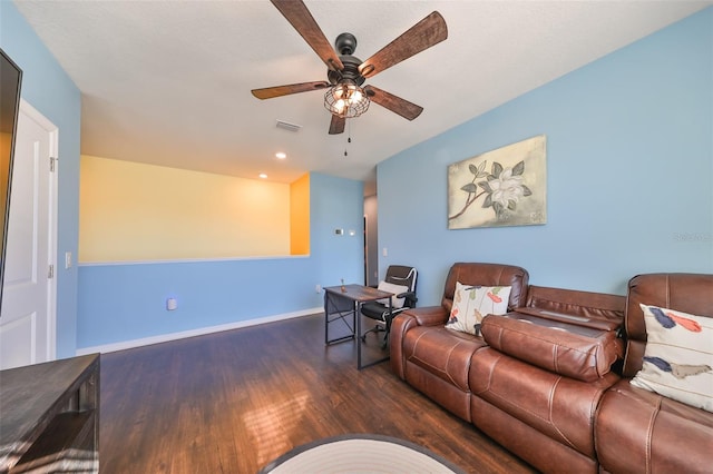 living room featuring ceiling fan and dark hardwood / wood-style floors