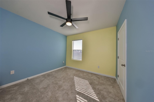 carpeted spare room with ceiling fan