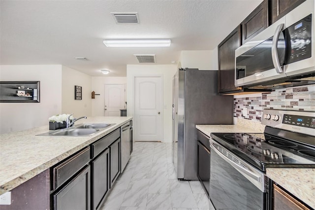 kitchen with decorative backsplash, sink, dark brown cabinets, and appliances with stainless steel finishes