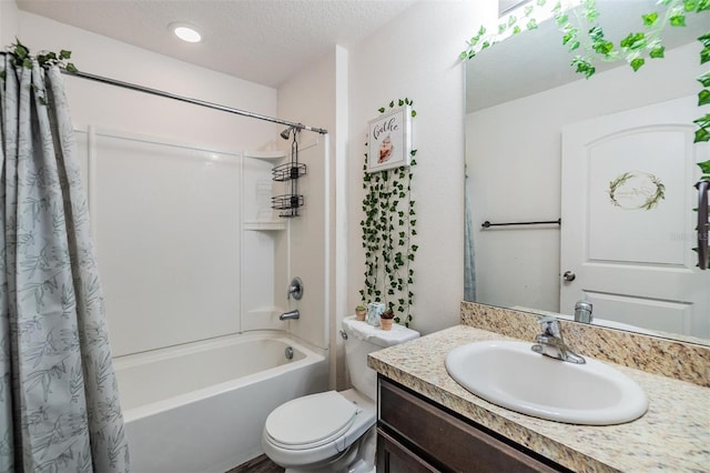 full bathroom featuring shower / bath combo with shower curtain, vanity, a textured ceiling, and toilet