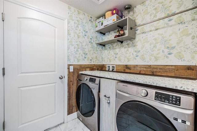 washroom featuring washer and dryer and a textured ceiling