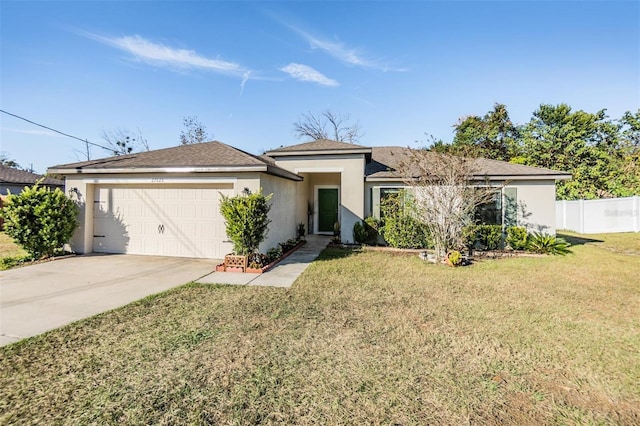 view of front of house with a front yard and a garage