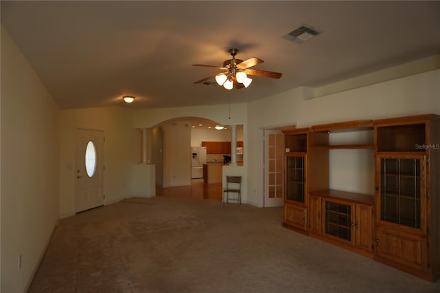 unfurnished living room with ceiling fan and carpet floors