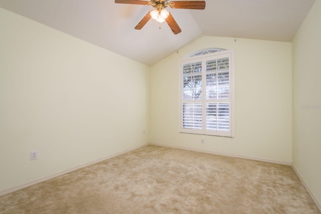 spare room featuring lofted ceiling, carpet flooring, and ceiling fan