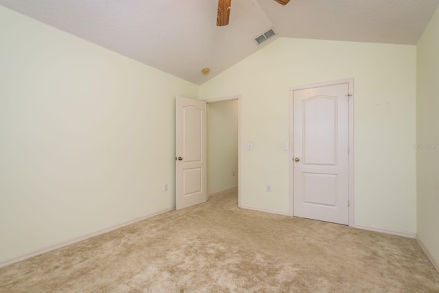 unfurnished bedroom with visible vents, a ceiling fan, lofted ceiling, and carpet floors