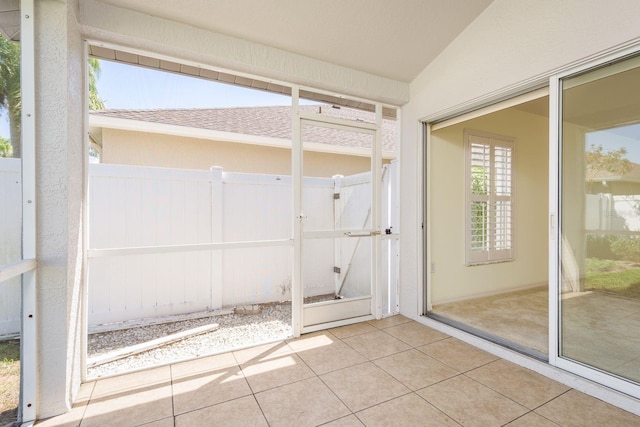 unfurnished sunroom with vaulted ceiling