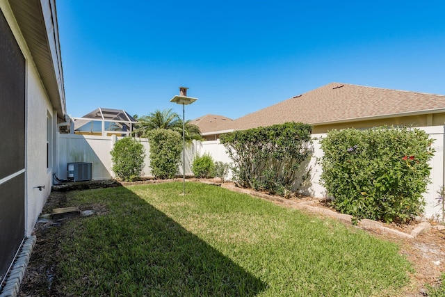 view of yard with central AC unit and a fenced backyard