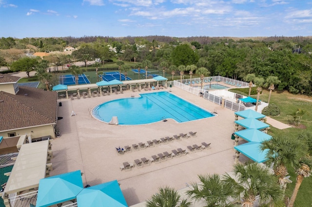 pool with a view of trees and fence