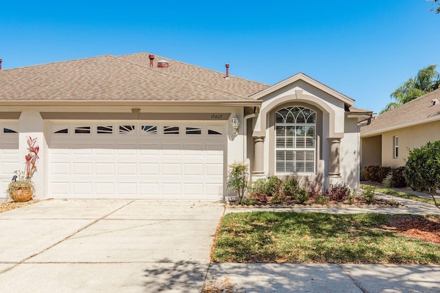 single story home featuring stucco siding, an attached garage, concrete driveway, and roof with shingles