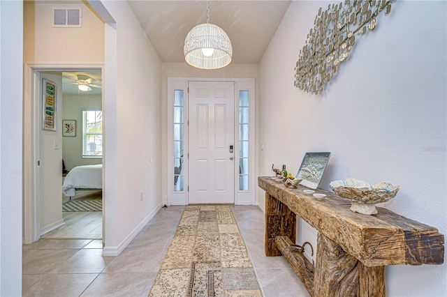 tiled entrance foyer featuring ceiling fan