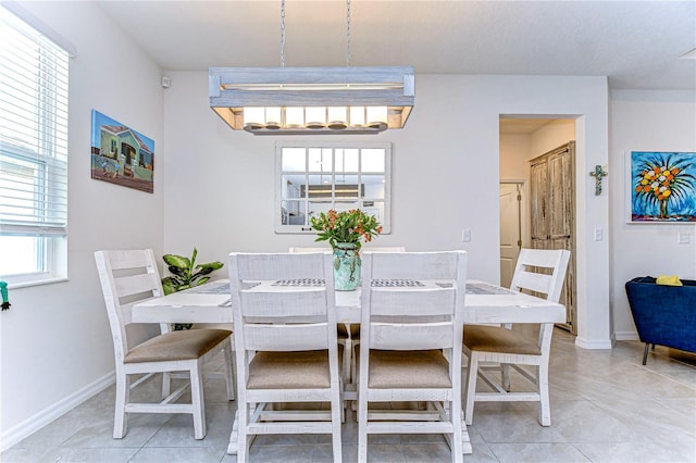 dining area featuring light tile patterned floors