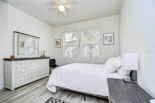 bedroom with ceiling fan and light wood-type flooring