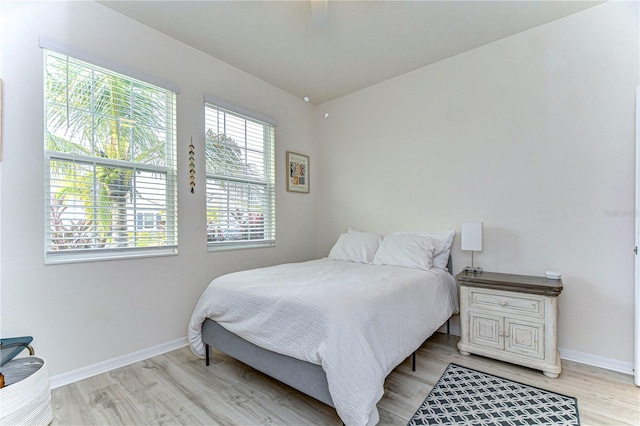 bedroom featuring light hardwood / wood-style floors and ceiling fan