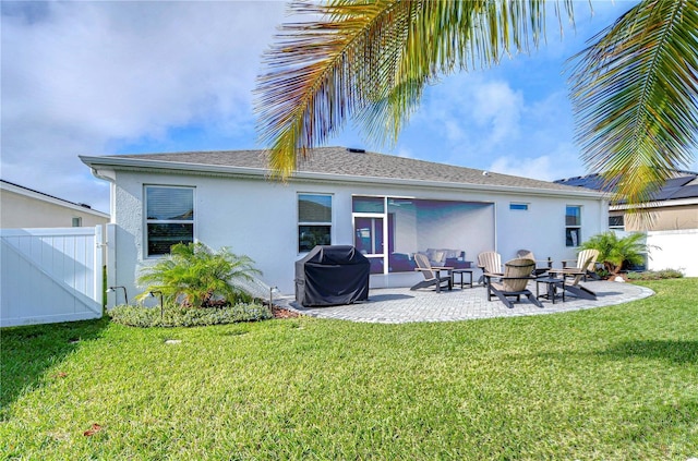 rear view of house with a yard and a patio area